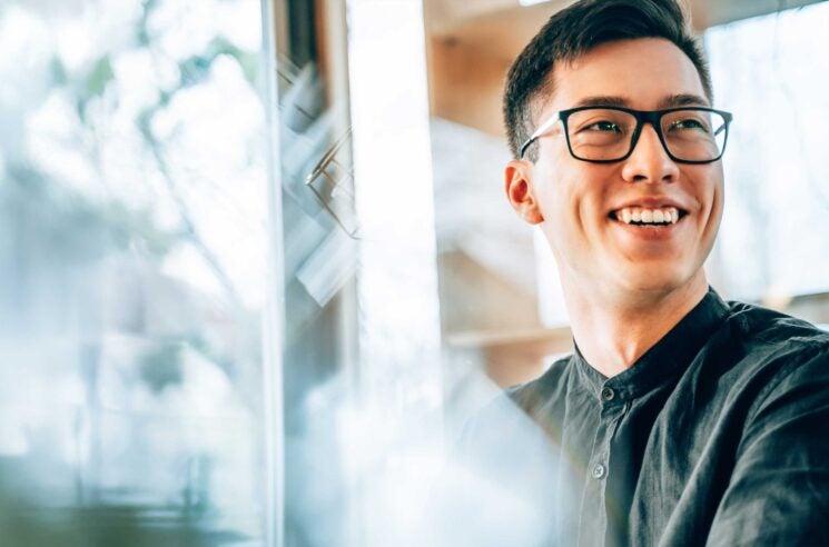 Man smiling at desk